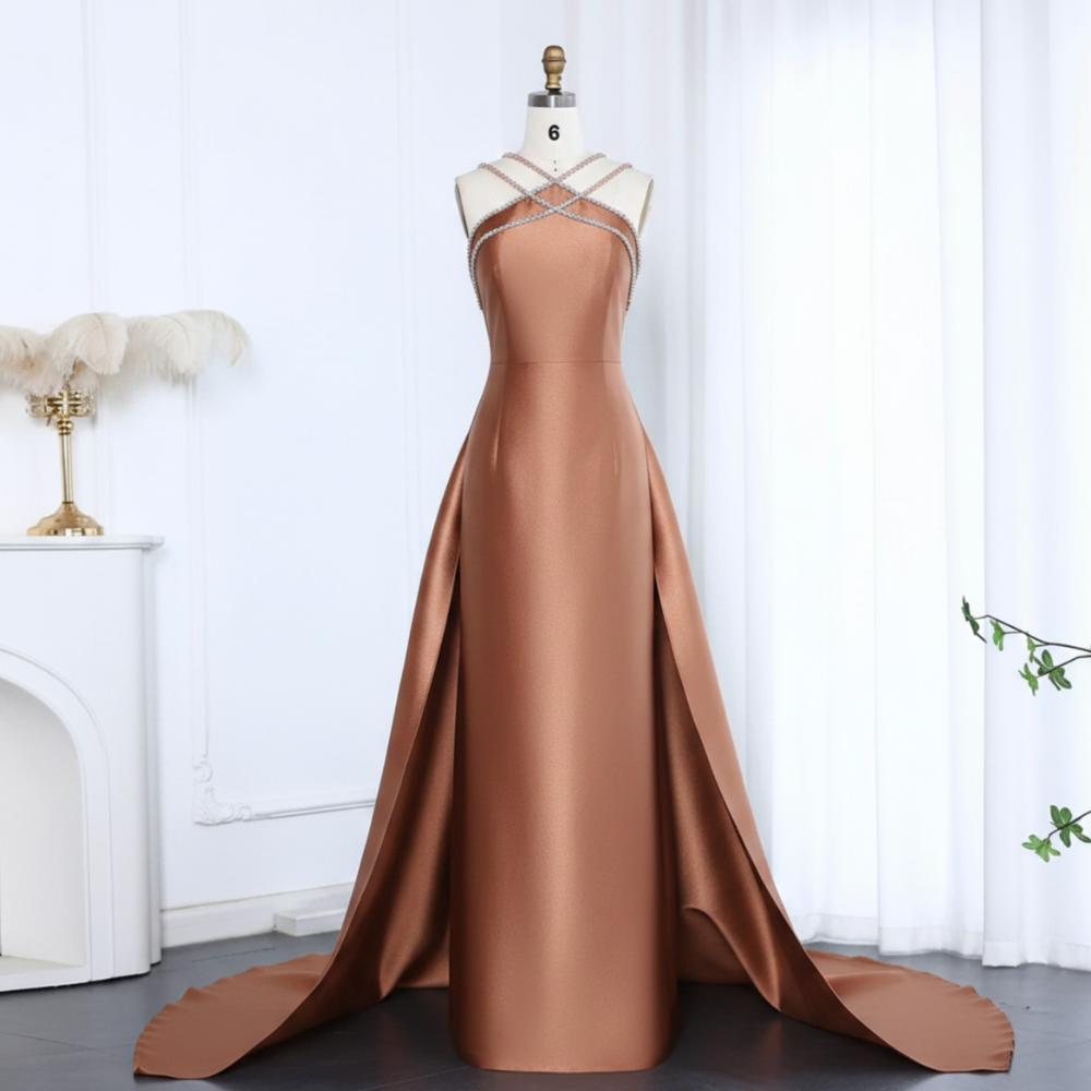 Bronze satin mermaid evening gown with a crystal-beaded halter neckline and dramatic detachable overskirt train.
