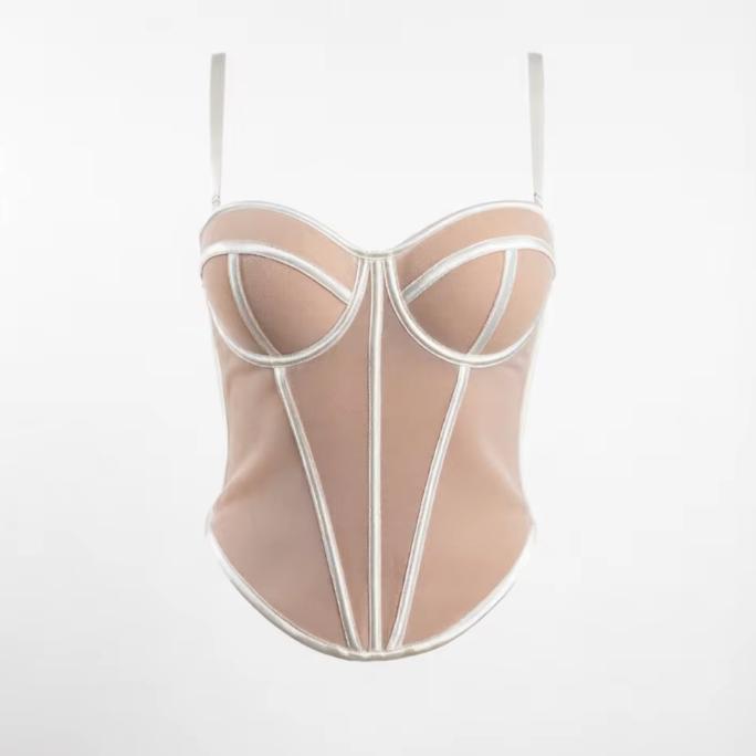 Beige handmade corset bustier with structured white piping, sweetheart neckline, and adjustable spaghetti straps.