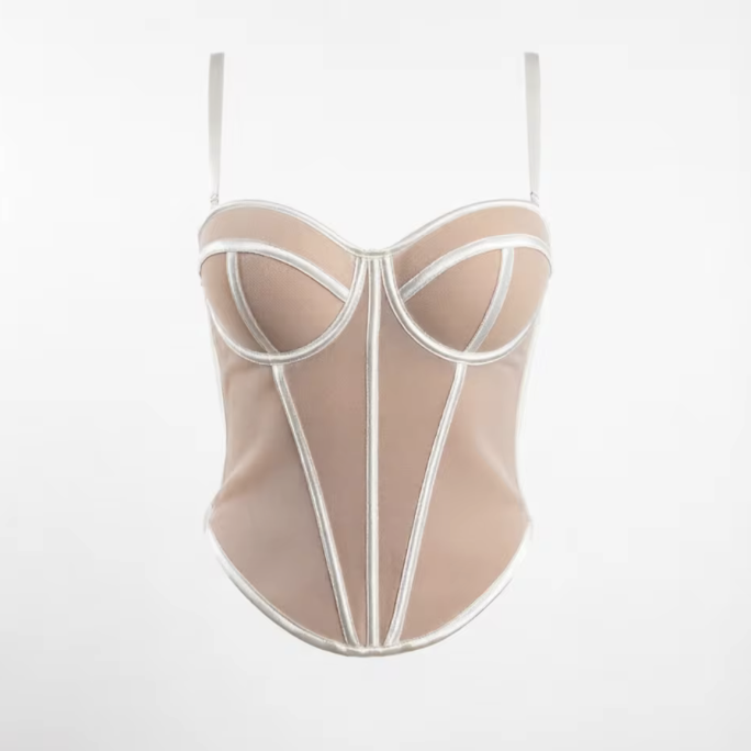 Beige handmade corset bustier with structured white piping, sweetheart neckline, and adjustable spaghetti straps.