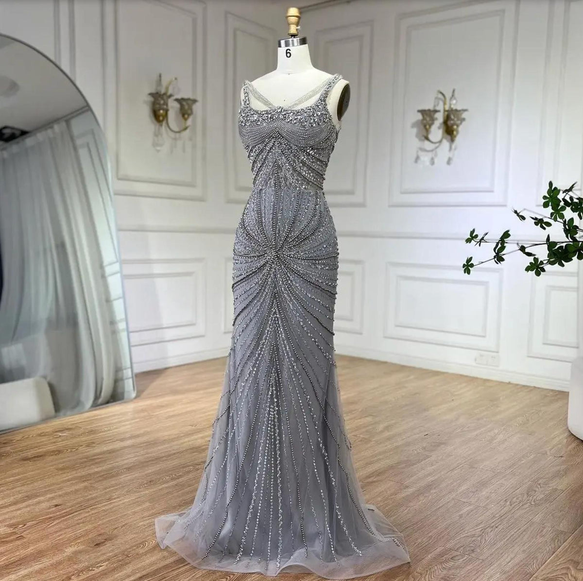 Nude mermaid gown with intricate crystal and sequin beading, spaghetti straps, and a square neckline on tulle.