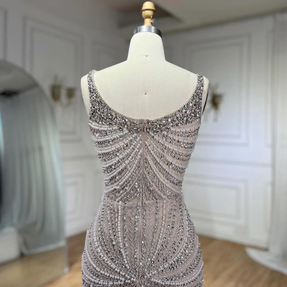 Nude mermaid evening gown with square neckline, featuring intricate hand-beaded crystals and sequins on tulle.