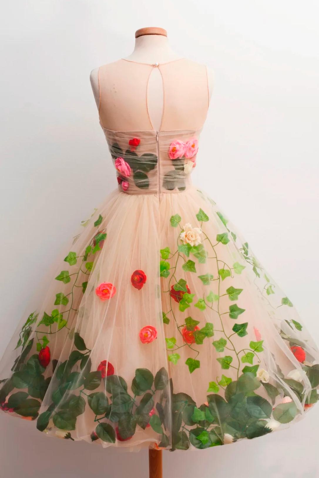 Nude tulle midi dress featuring 3D red rose appliqués and green leaf vine embroidery with a scoop back.
