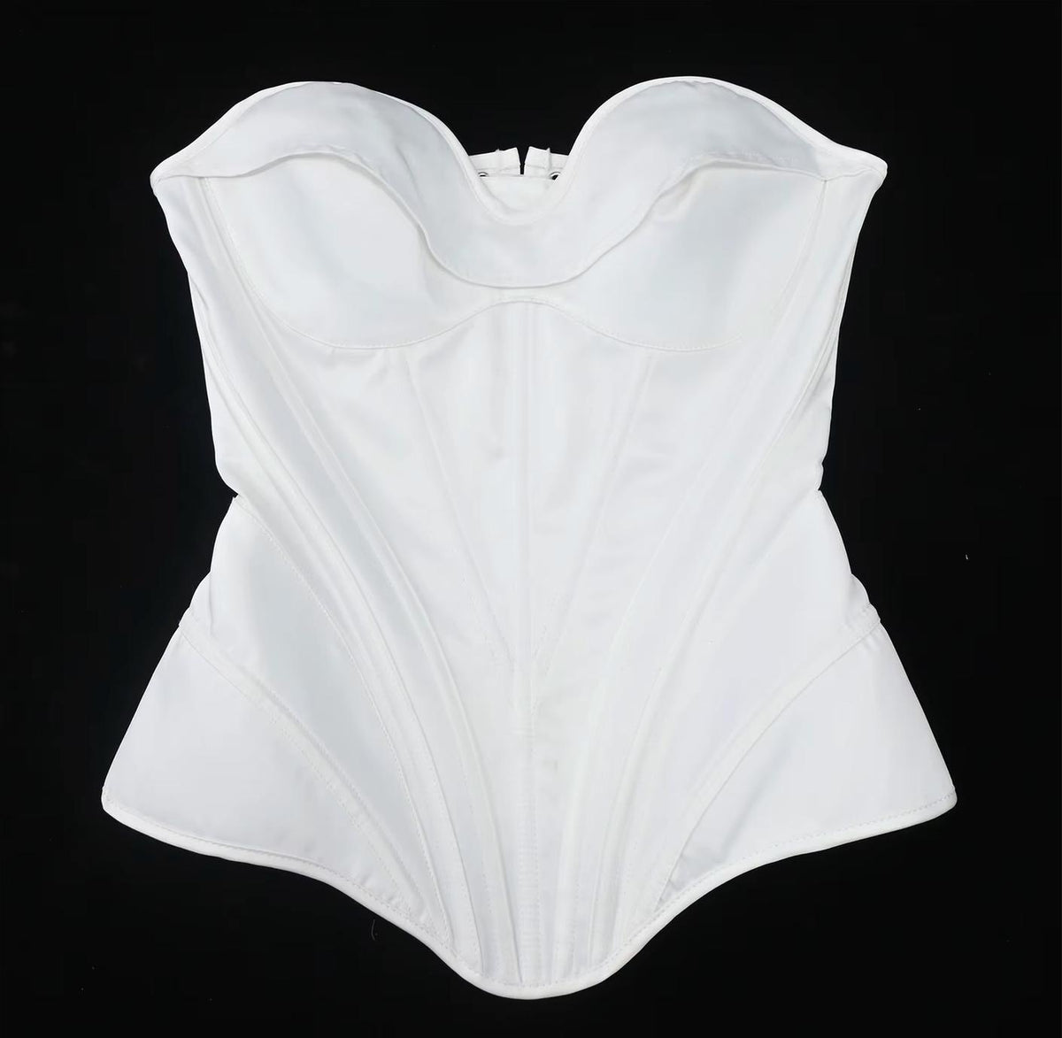 White satin strapless corset bustier with structured boning and a sweetheart neckline on a black background.