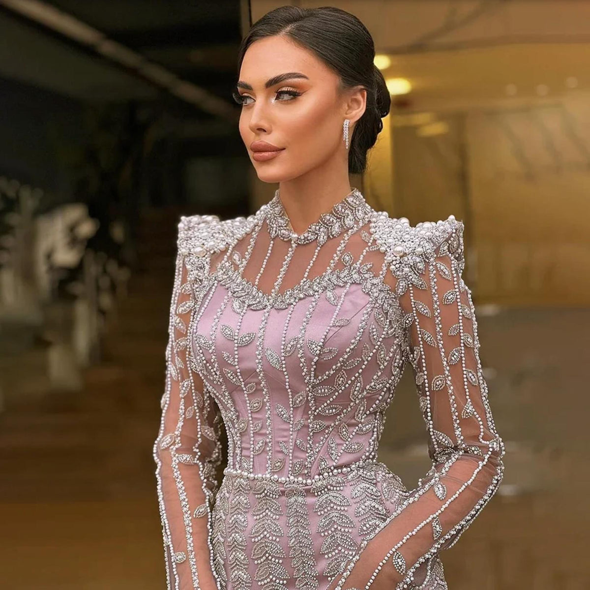 Lavender mermaid gown featuring intricate pearl and crystal beadwork, long sheer sleeves, and a structured o-neck bodice.