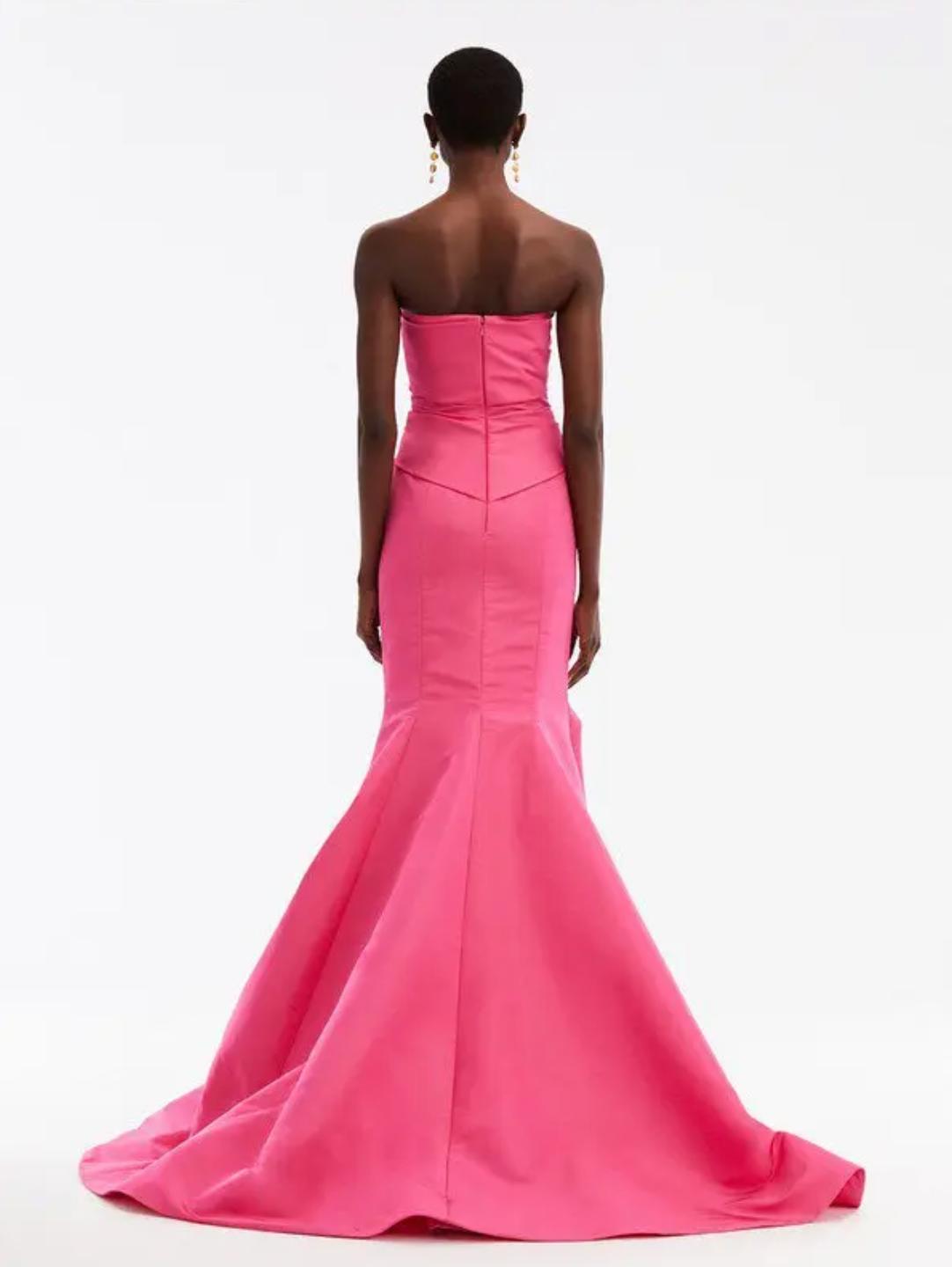 Back view of a hot pink silk faille strapless mermaid ballgown with a fluted skirt and floor-sweeping train.