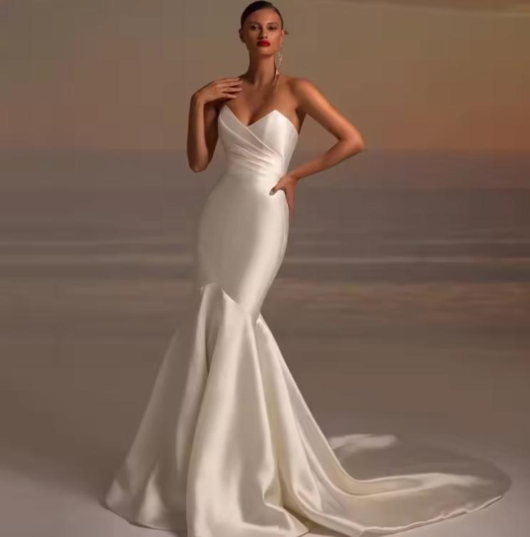 Elegant white satin fishtail gown with pleated bodice and sweetheart neckline for formal events.