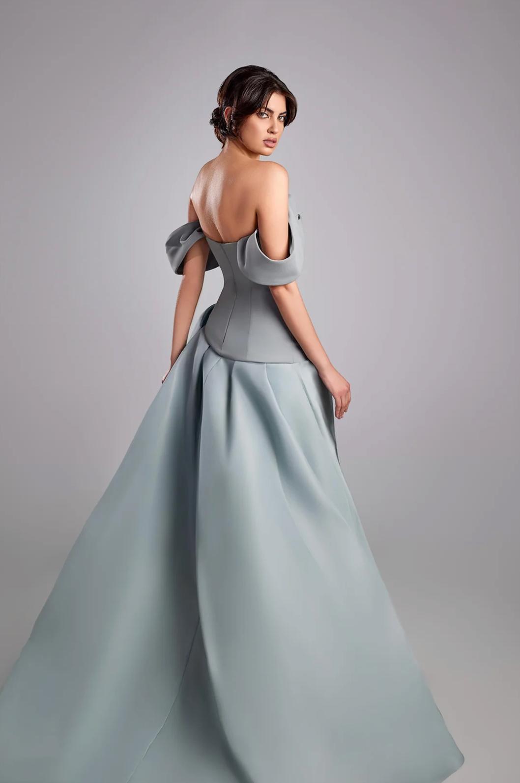 Elegant grey off-shoulder gown with a structured pleated satin bodice and a voluminous mikado satin skirt.