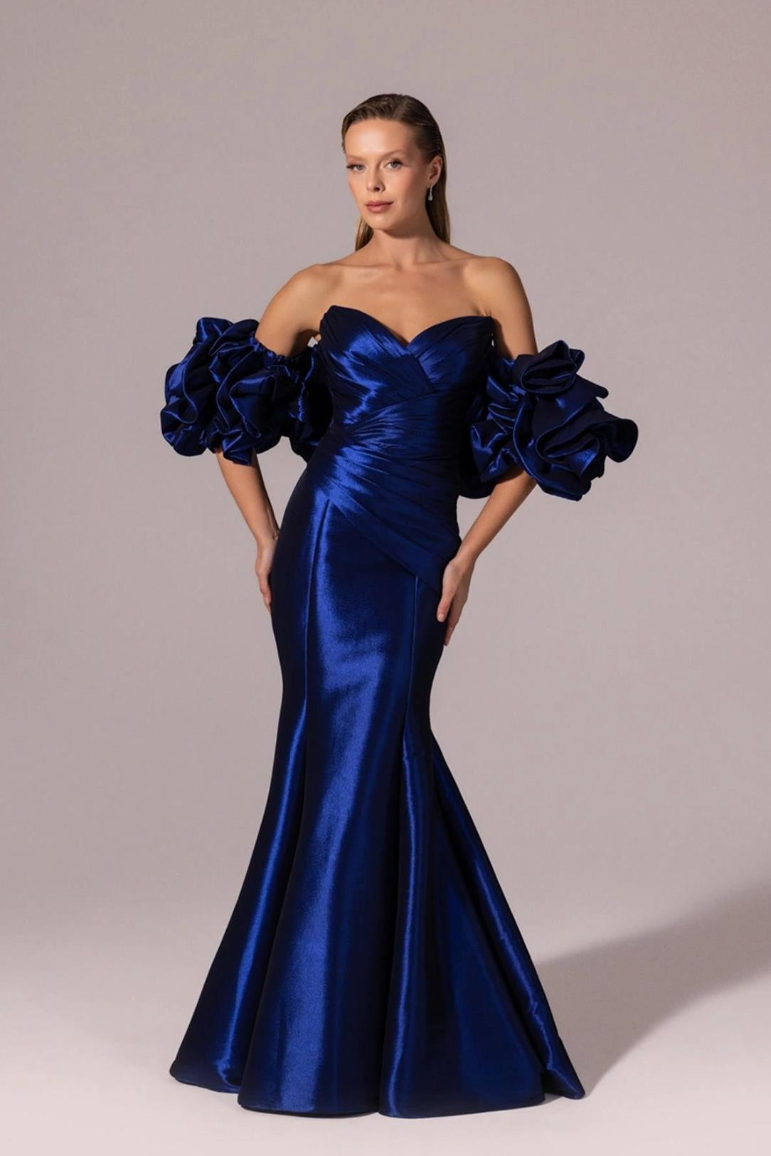 Royal blue satin mermaid evening gown with off-the-shoulder ruffled sleeves and a sweetheart neckline.
