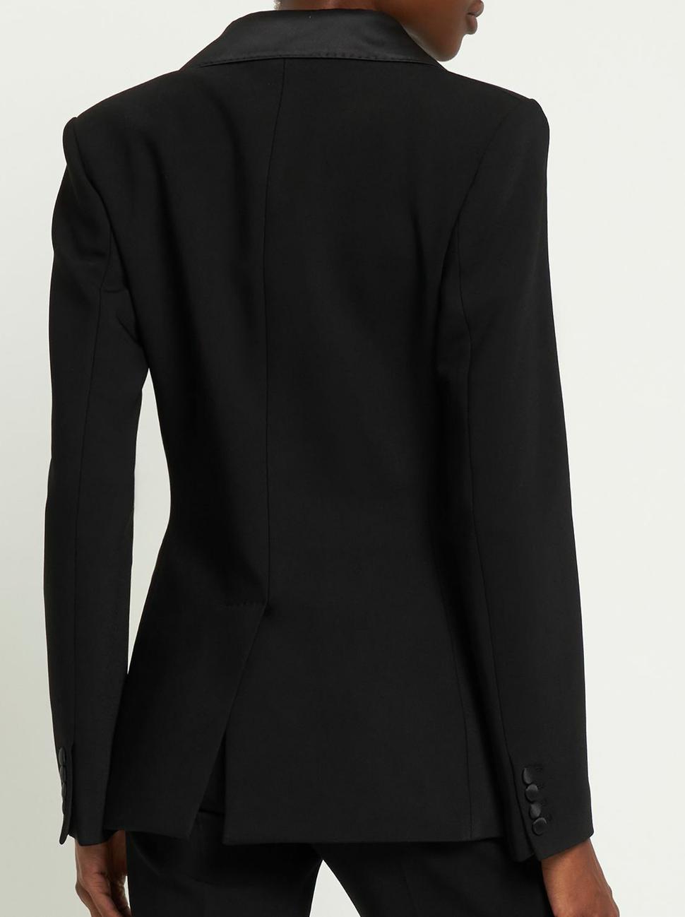 Back view of a black Brioni Vanqui suit jacket featuring a sharp tailored fit, satin lapel detail, and buttoned cuffs.