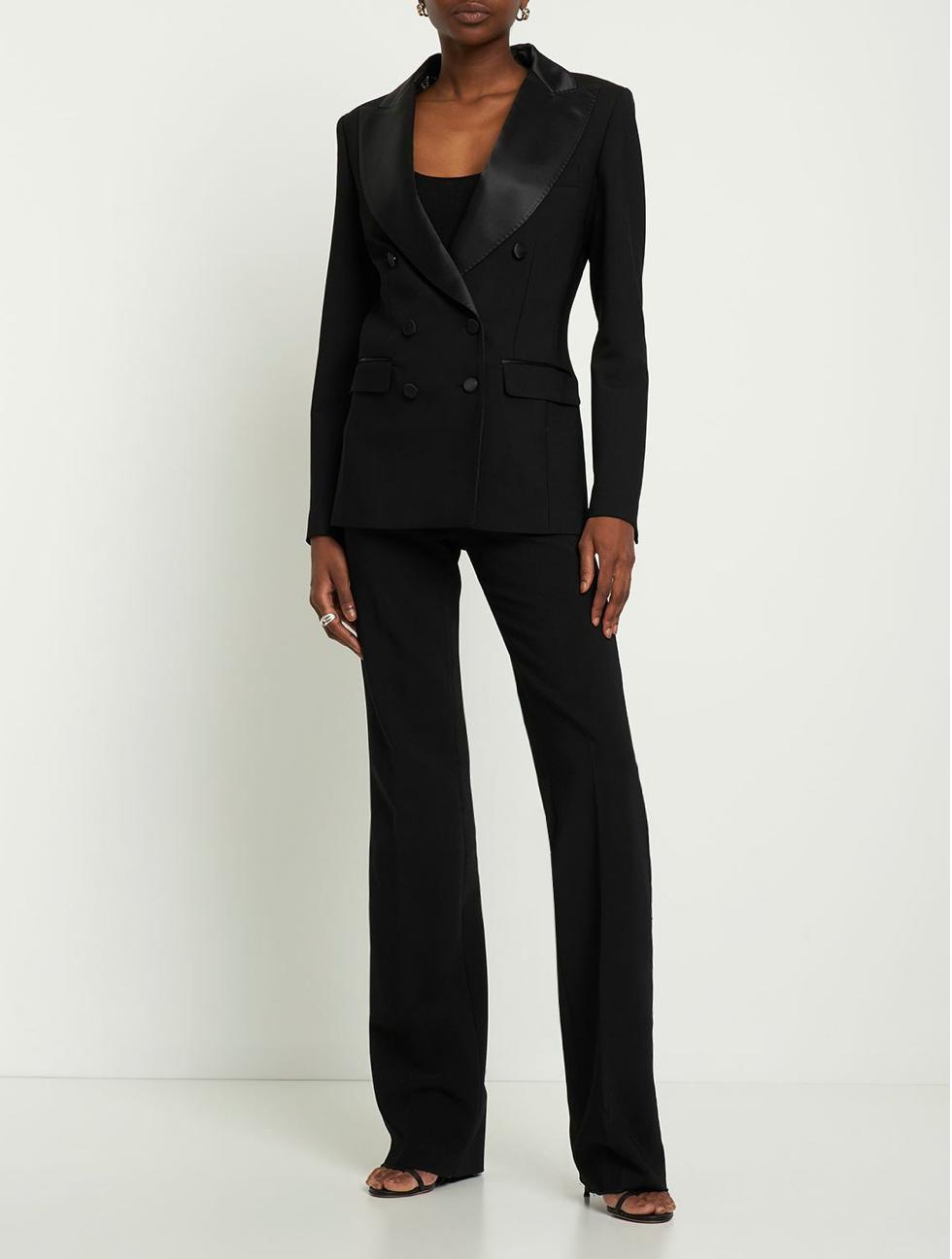 Black Brioni Vanqui double-breasted suit with satin peaked lapels, tailored pockets, and matching trousers.