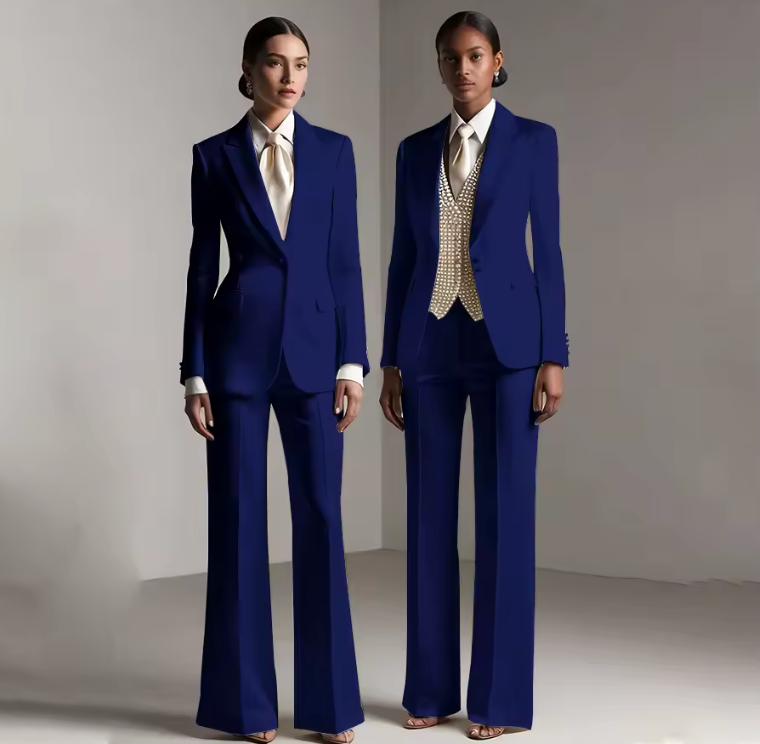 Two models wearing tailored royal blue satin single-breasted pantsuits with white shirts and professional silhouettes.