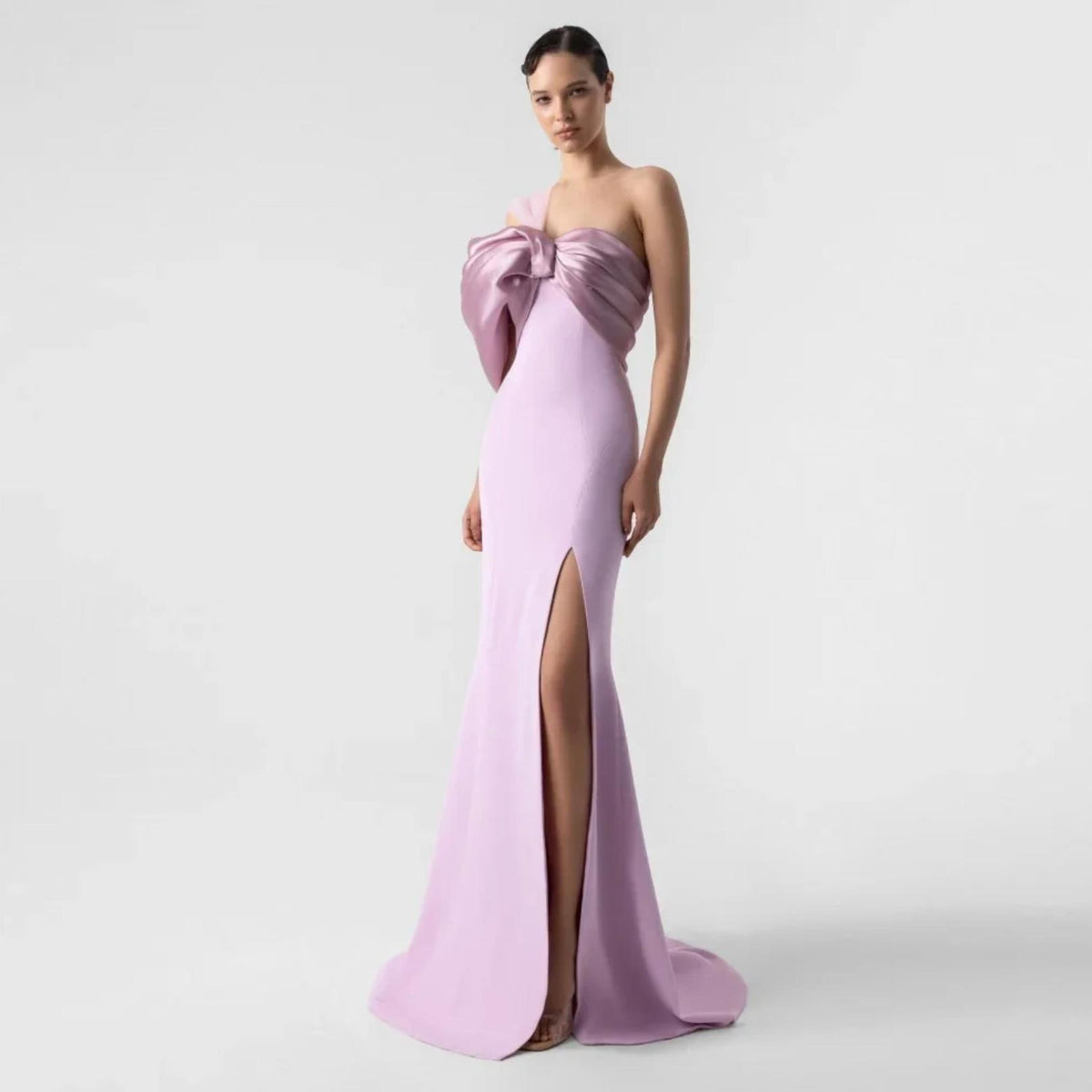 Lavender satin one-shoulder evening gown with a dramatic bow detail and floor-length side split.