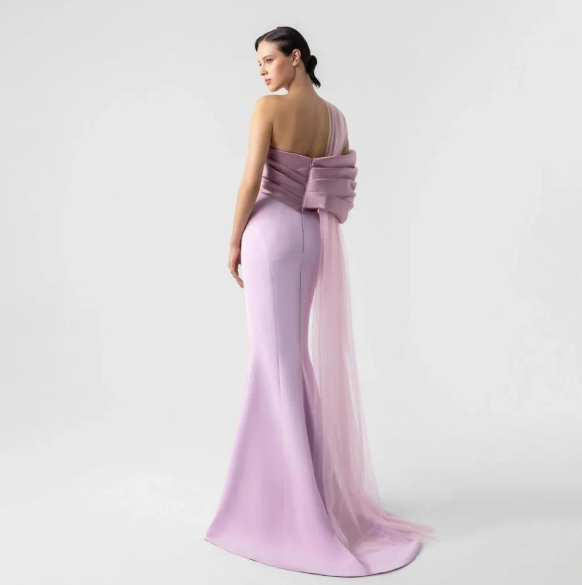 Lavender satin one-shoulder evening gown with a dramatic back bow and flowing organza train.
