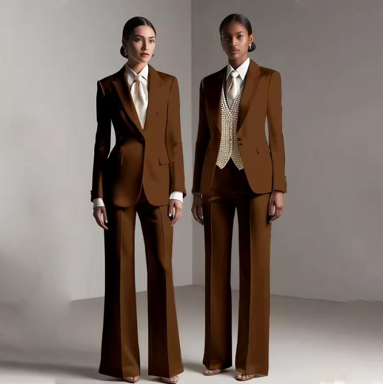 Two models wearing Brisbane brown satin single-breasted pantsuits with tailored jackets and coordinating trousers.