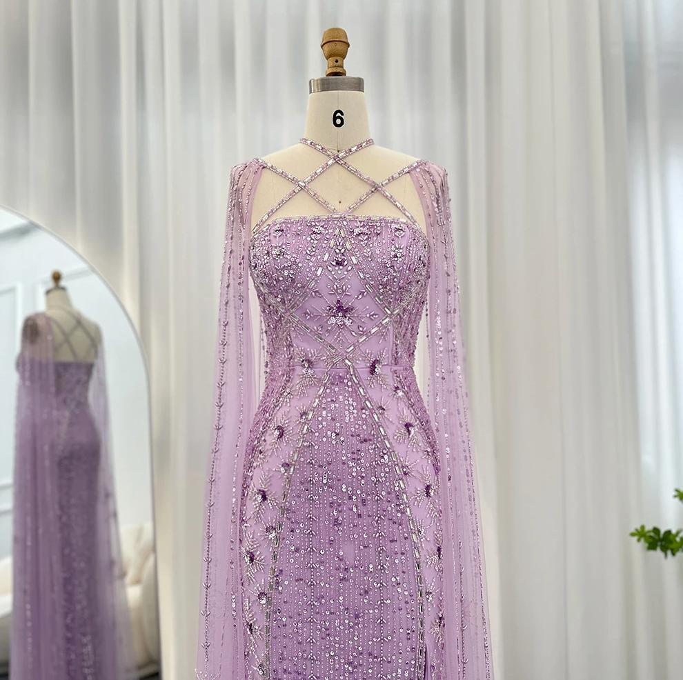 Lavender mermaid gown with criss-cross neckline, cape sleeves, and intricate crystal and sequin tulle embellishments.