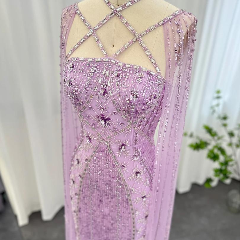 Lavender tulle mermaid gown with a criss-cross neckline, dramatic cape sleeves, and intricate crystal and sequin beading.