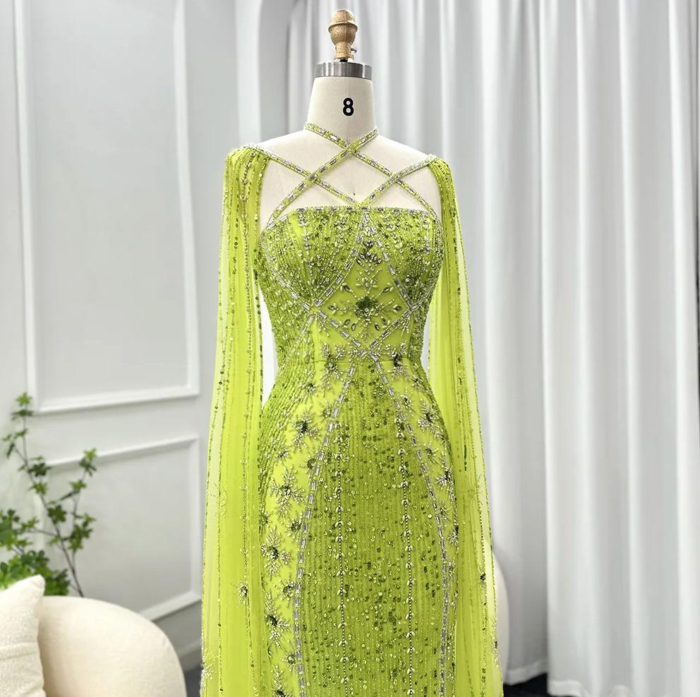 Lime green mermaid gown with cape sleeves, criss-cross neckline, and intricate crystal and sequin beadwork on tulle.