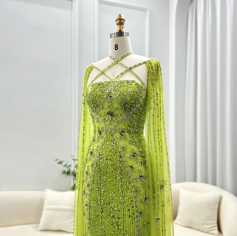 Lime green mermaid gown with cape sleeves, criss-cross neckline, and intricate crystal and sequin tulle detailing.