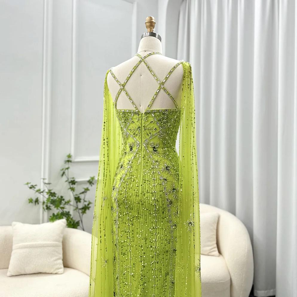 Lime green mermaid gown with cape sleeves, criss-cross back, and intricate crystal and sequin embellishments.