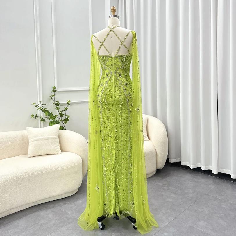 Lime green mermaid gown with cape sleeves, criss-cross back, and intricate crystal and sequin embellishments on tulle.