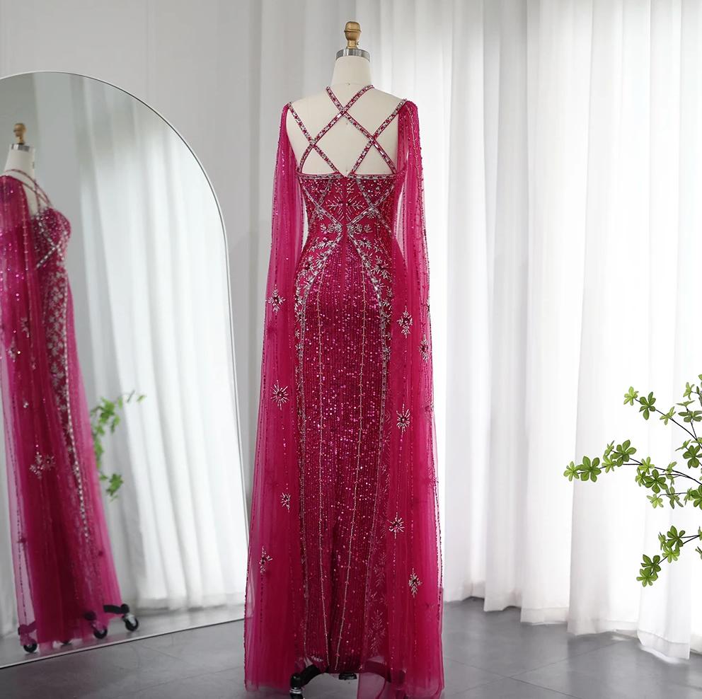 Magenta mermaid gown with cape sleeves, criss-cross back, and intricate crystal and sequin embellishments on tulle.