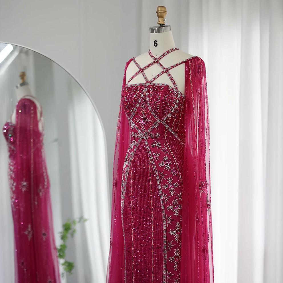 Magenta mermaid gown with cape sleeves, criss-cross neckline, and intricate crystal and sequin beadwork on a mannequin.