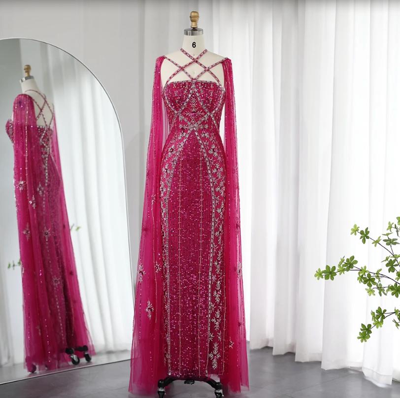 Magenta mermaid gown with cape sleeves, criss-cross neckline, and intricate crystal and sequin beadwork on tulle.