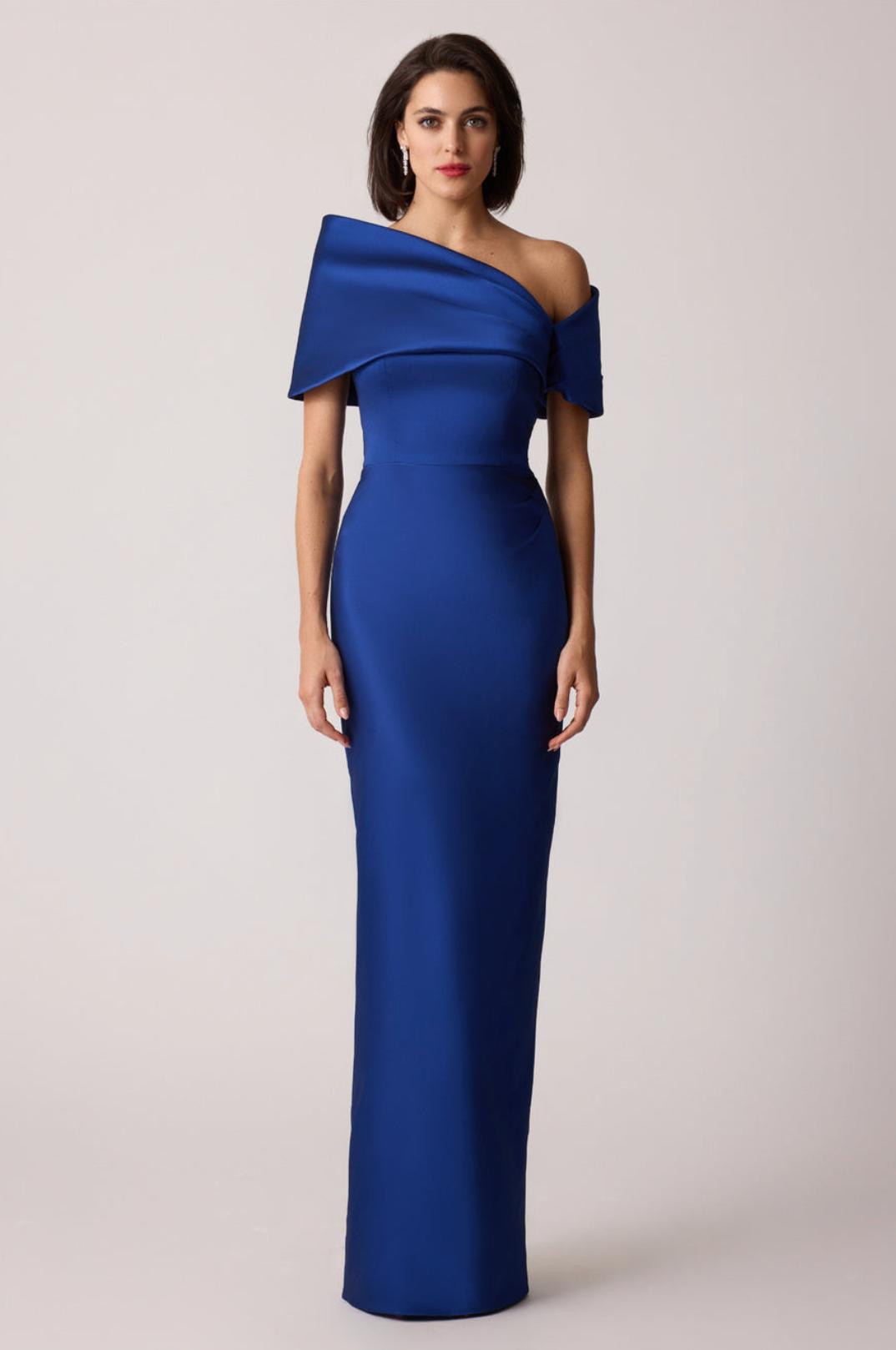Royal blue stretch-mikado floor-length gown with an asymmetrical off-shoulder neckline and sculptural arm cuff.