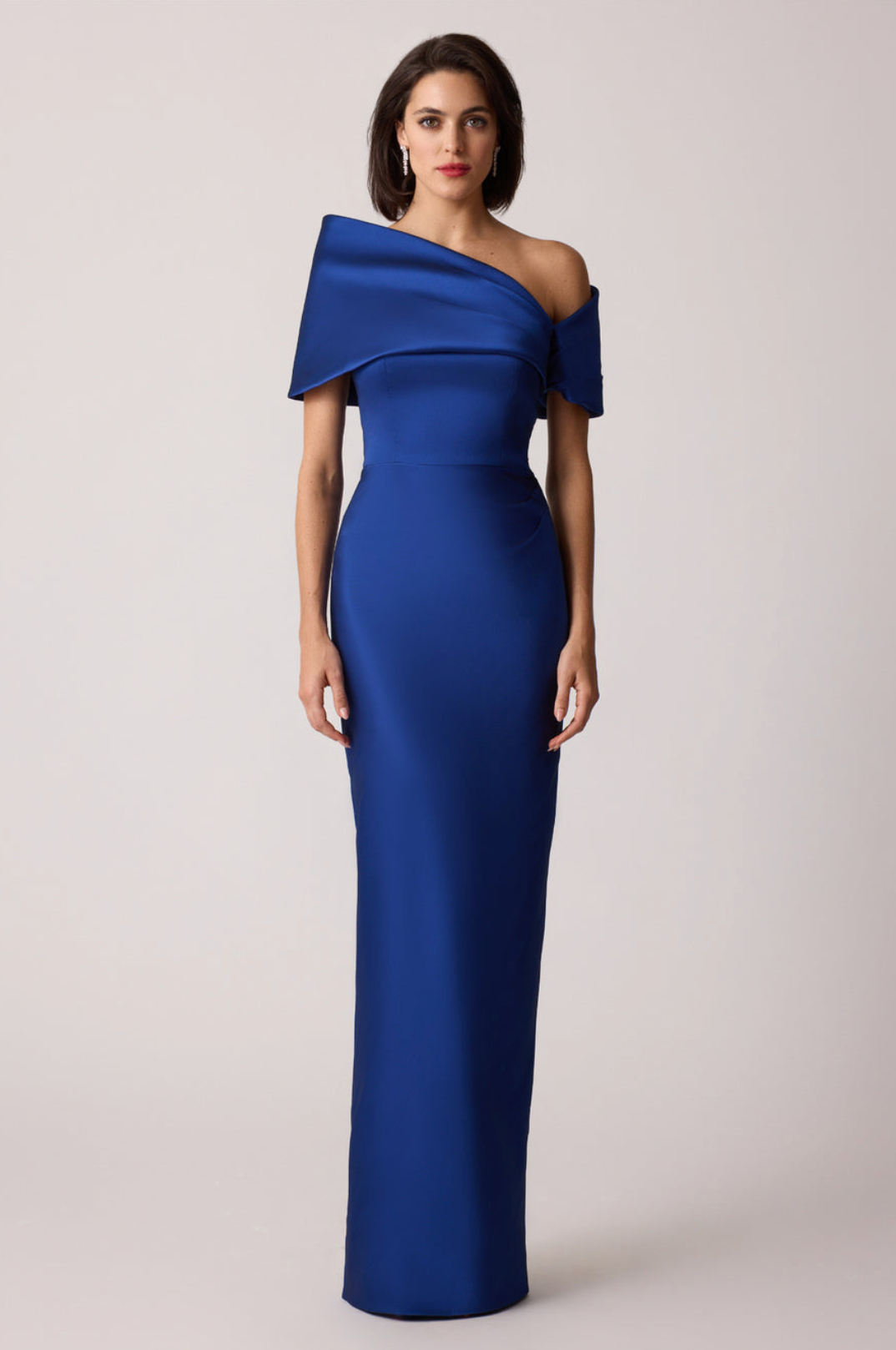 Royal blue stretch-mikado floor-length gown with an asymmetrical off-shoulder neckline and sculptural arm cuff.