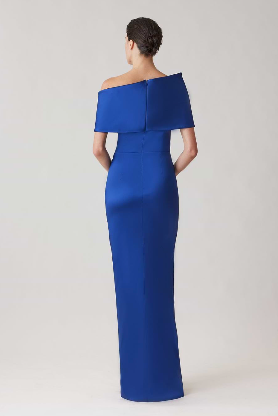 Royal blue stretch-mikado floor-length gown with an asymmetrical off-shoulder neckline and sculptural cuff.