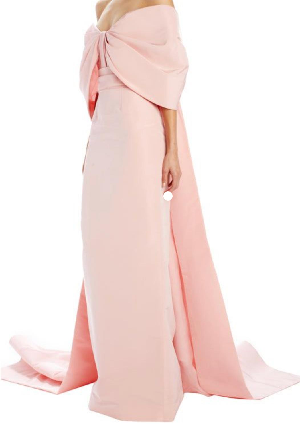 Blush pink satin off-the-shoulder gown with a dramatic bow, ruched bodice, and a floor-length trumpet train.