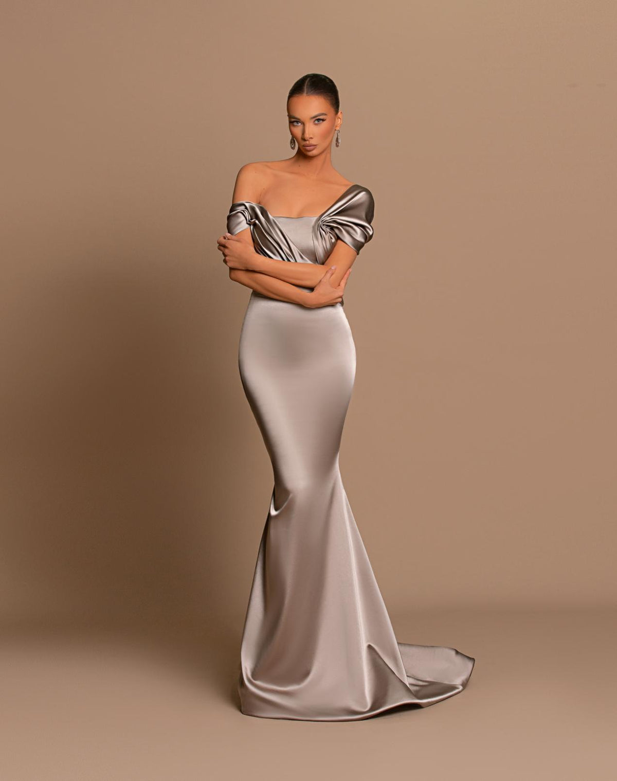 Chrome off-shoulder maxi gown in metallic satin with a structured corset bodice and elegant draped detailing.