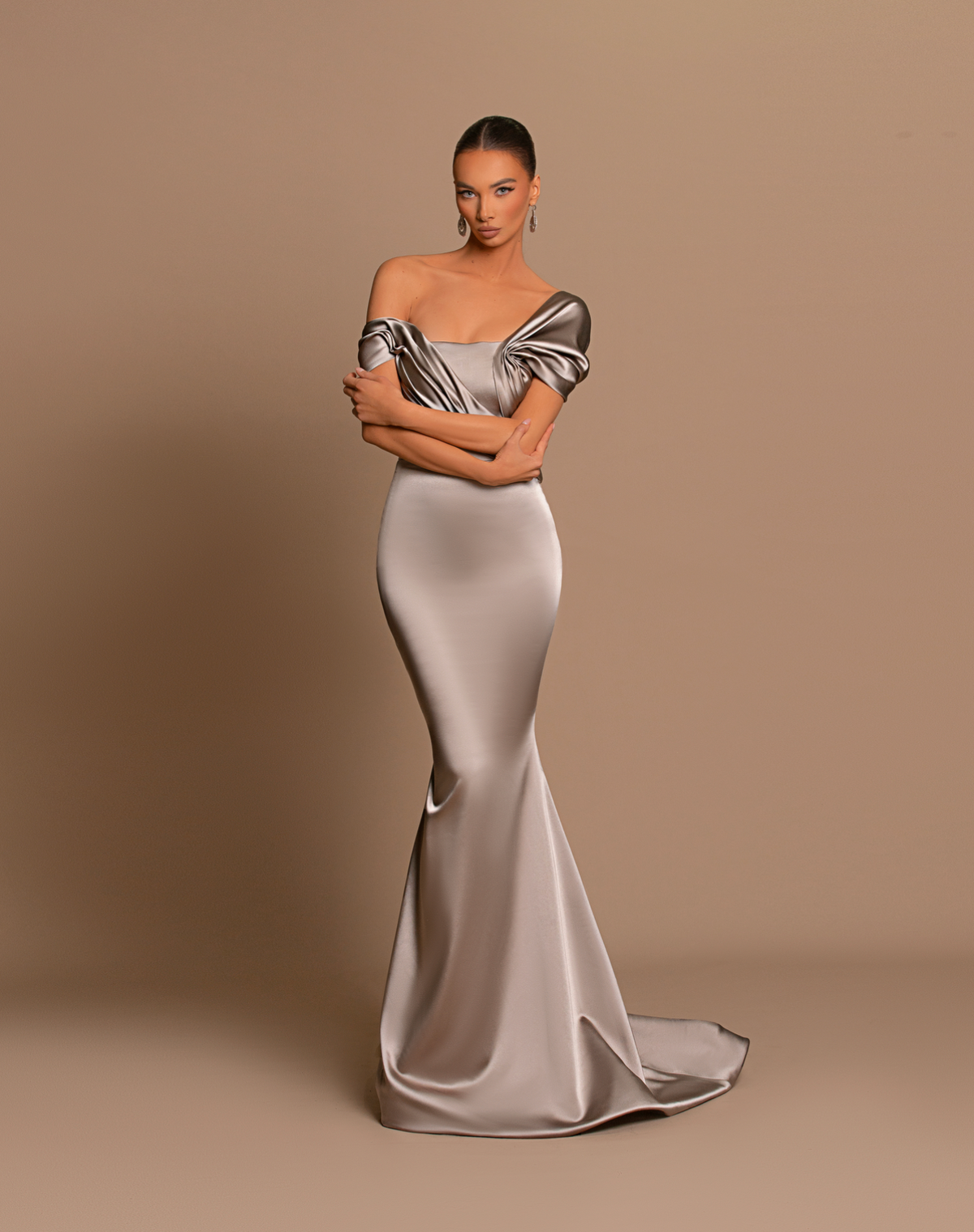 Chrome off-shoulder maxi gown in metallic satin with a structured corset bodice and elegant draped detailing.