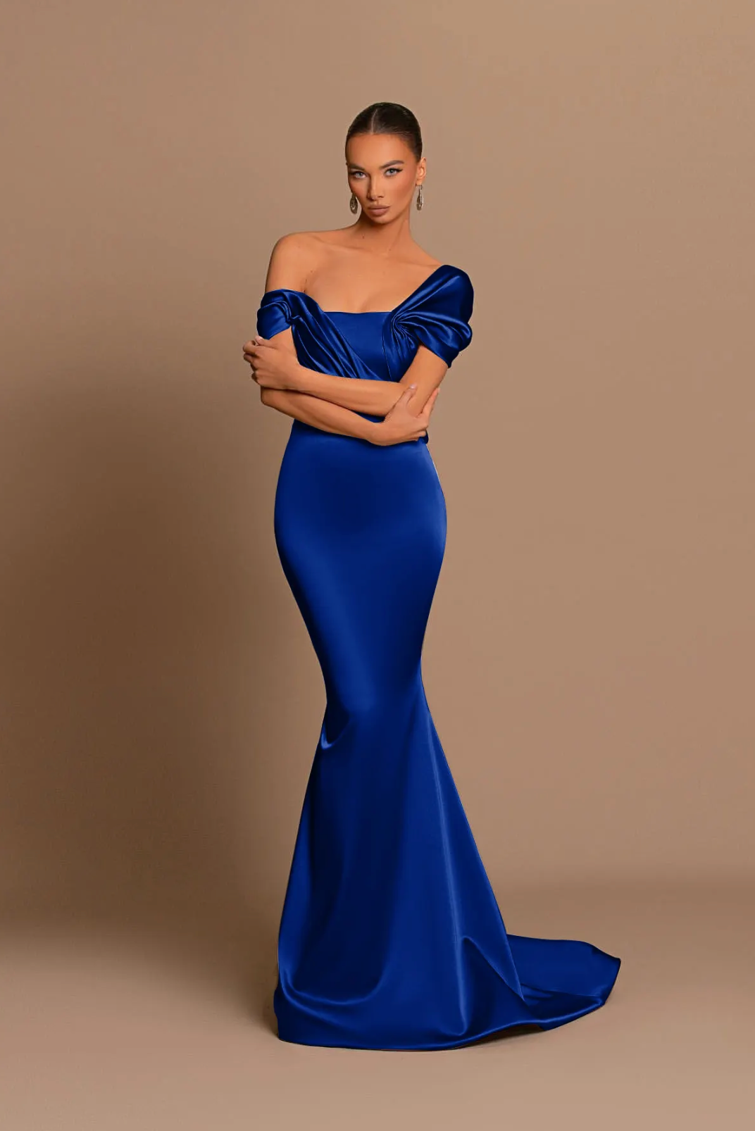 Royal blue off-shoulder satin maxi gown with a structured corset bodice and cascading draped detailing.