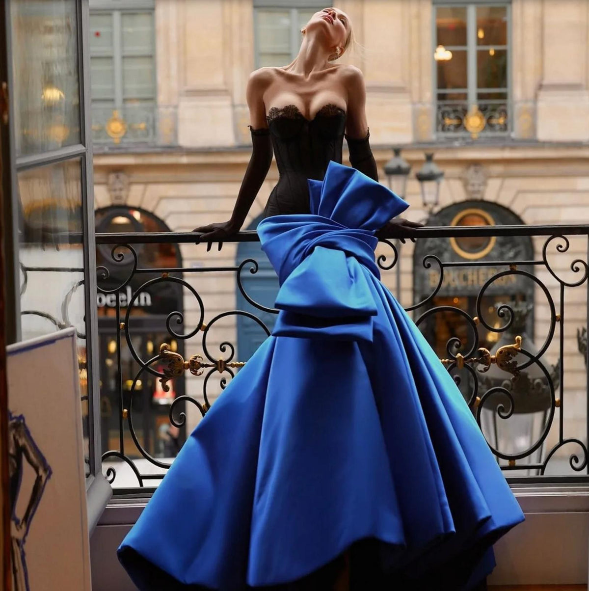Concavo mermaid gown with a black corset bustier and a vibrant blue satin skirt featuring a large statement bow.