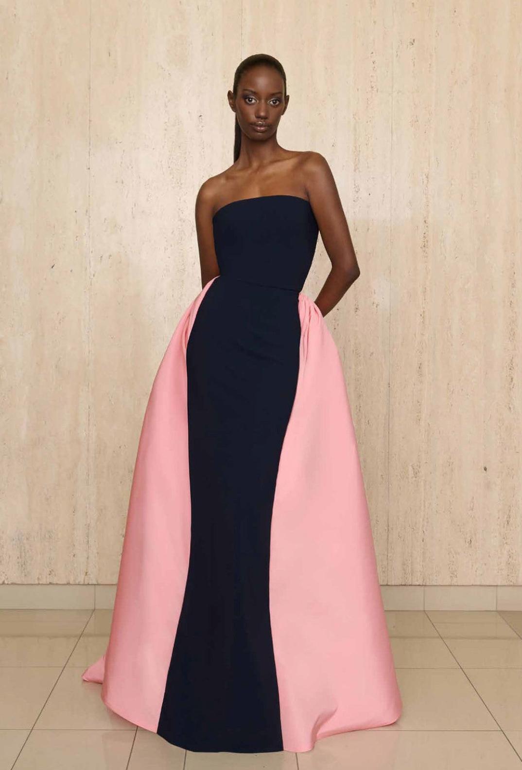 Strapless navy blue silk faille gown featuring a dramatic, contrasting light pink cape overlay for formal events.