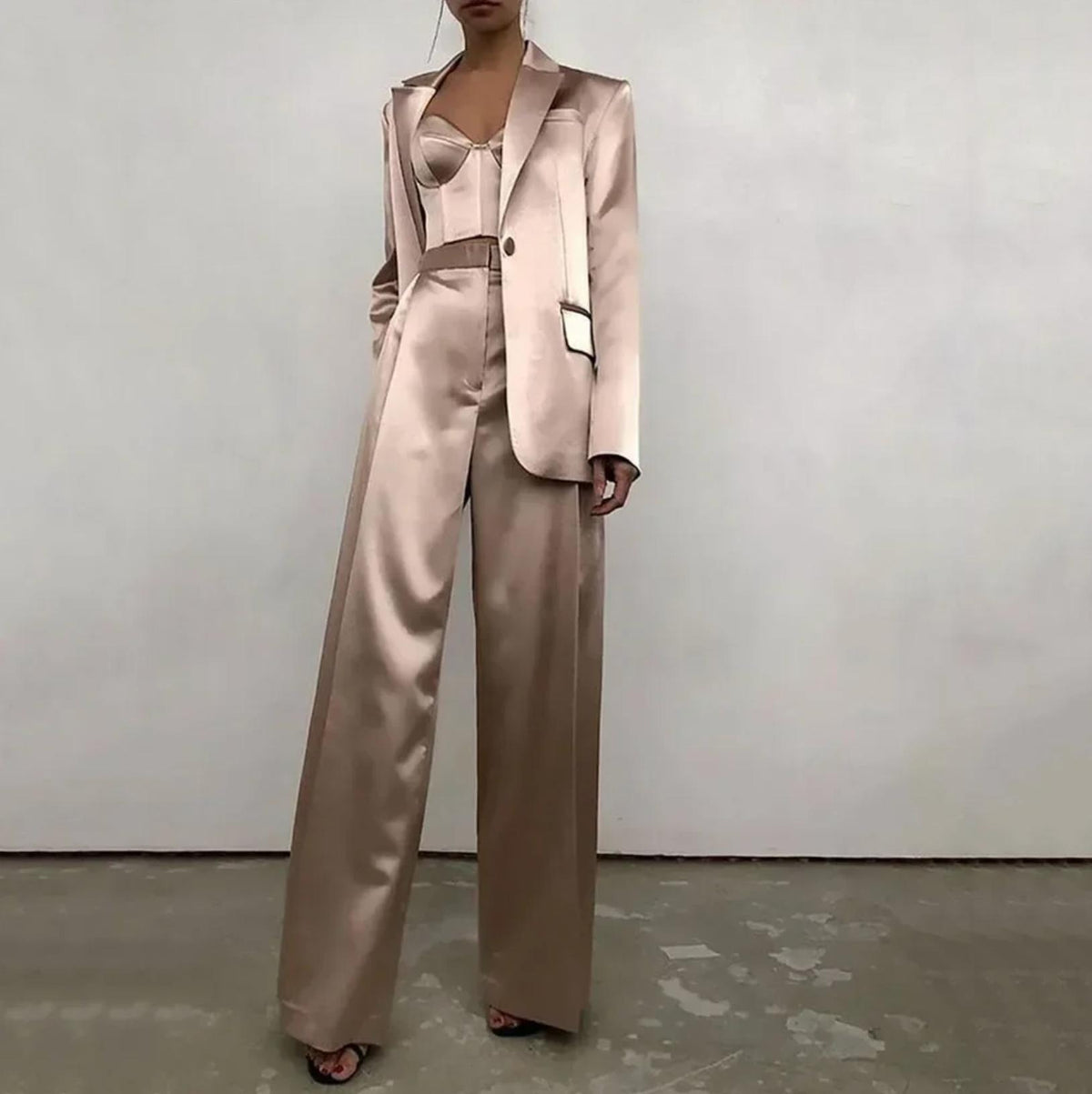Champagne satin two-piece suit with a single-button blazer, corset top, and high-waisted wide-leg trousers.