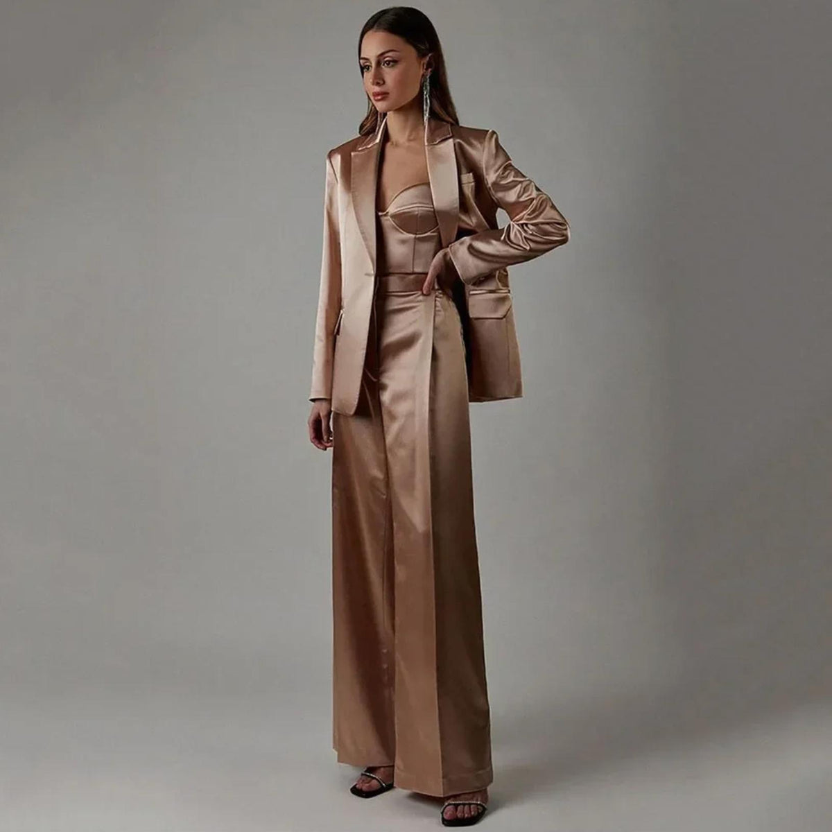 Champagne satin two-piece suit with a sharp blazer, corset top, and high-waisted wide-leg trousers.