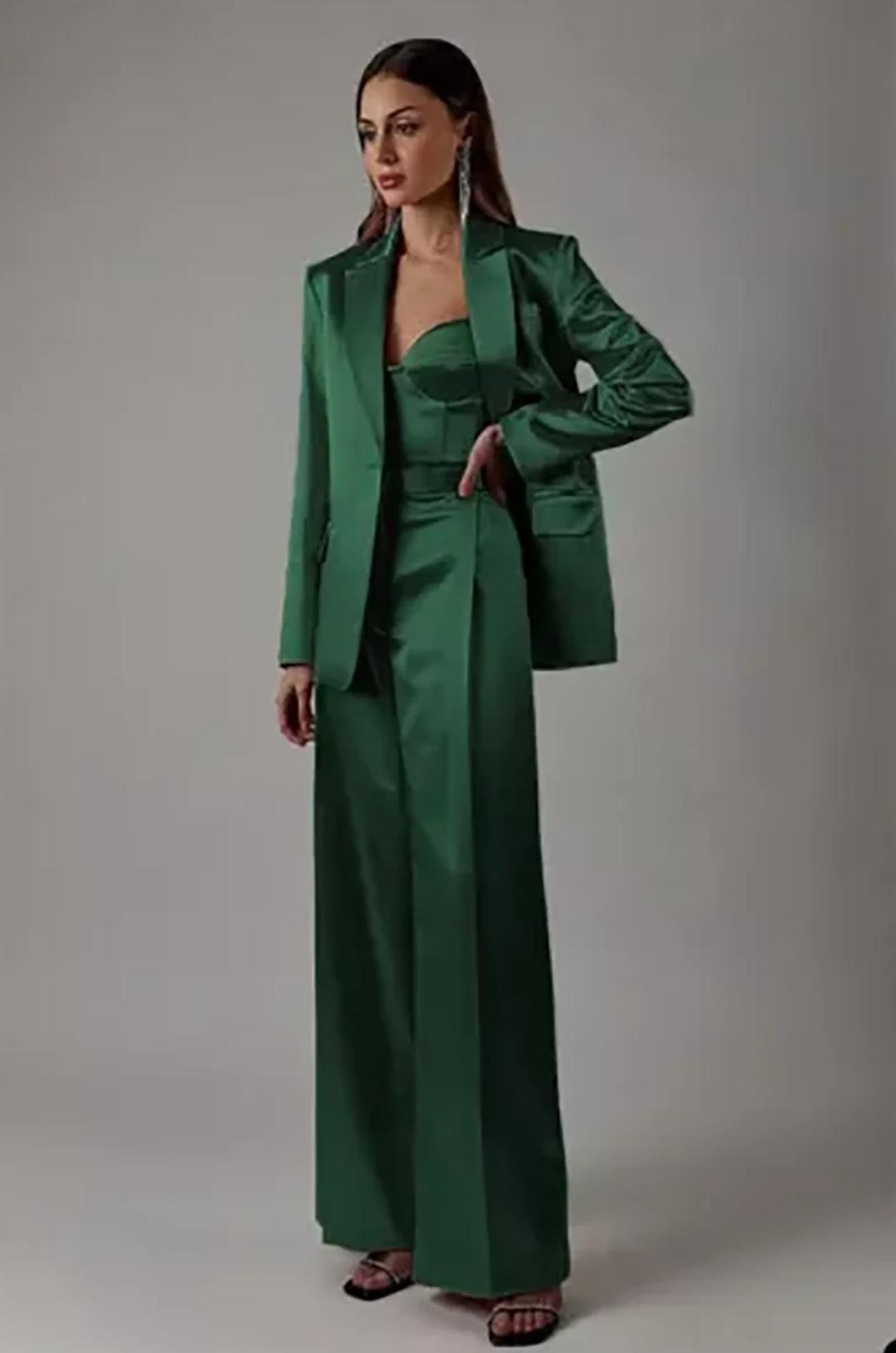 Emerald green satin two-piece suit with a single-button blazer and high-waisted wide-leg trousers.