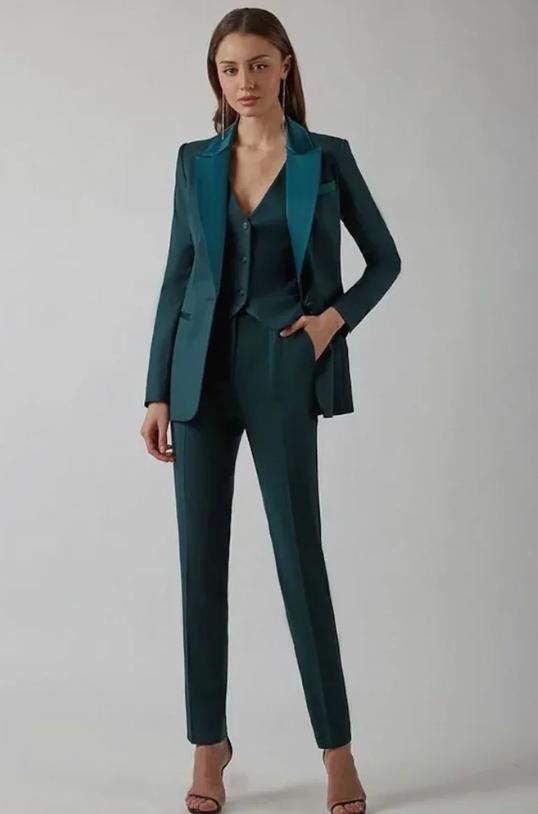 Woman wearing a dark green Italian satin three-piece suit set with a single-breasted blazer, tailored vest, and sharp pants.