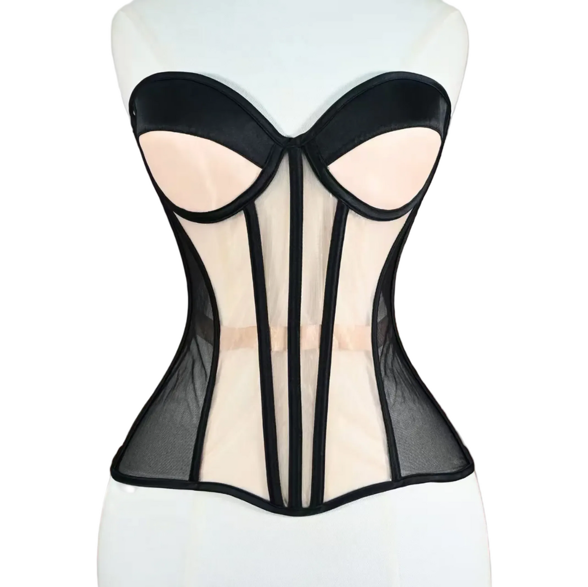 Black and nude mesh strapless corset with structured boning and architectural paneling on a mannequin.