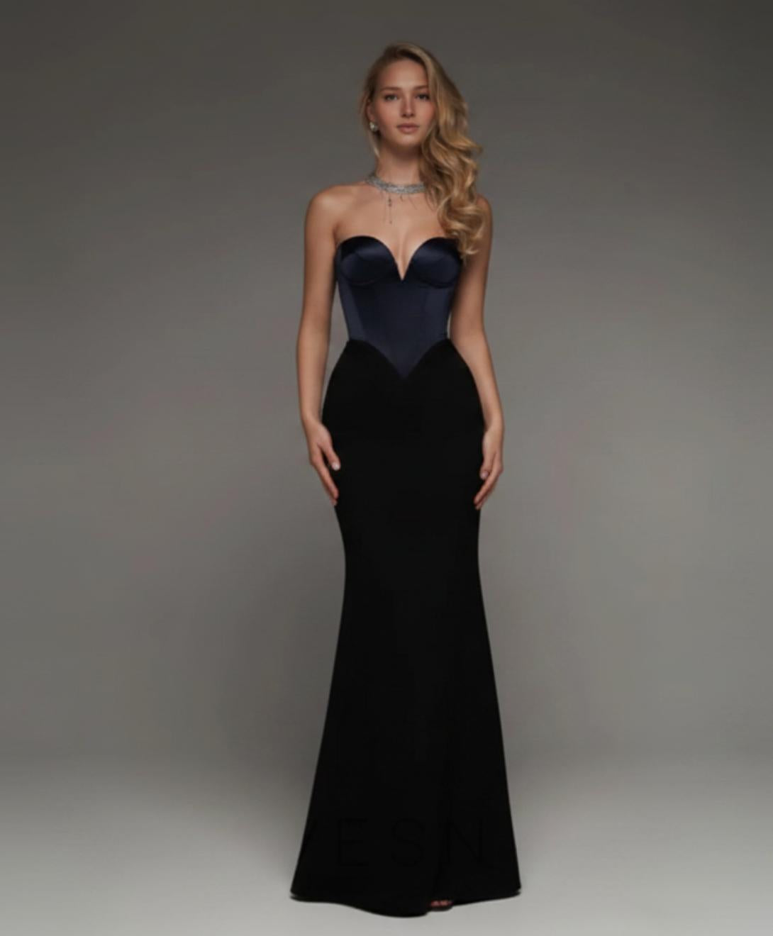Strapless black mermaid gown with a sweetheart neckline, satin bodice, and floor-length silhouette.