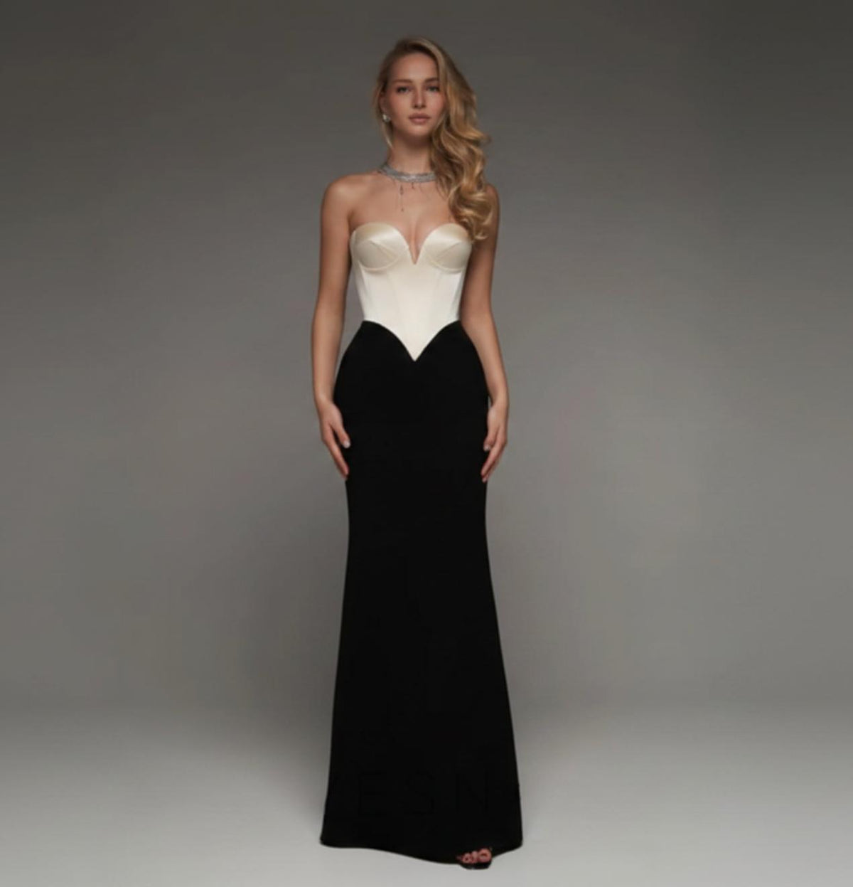 Strapless mermaid wedding dress with a white satin sweetheart bodice and a floor-length black skirt.