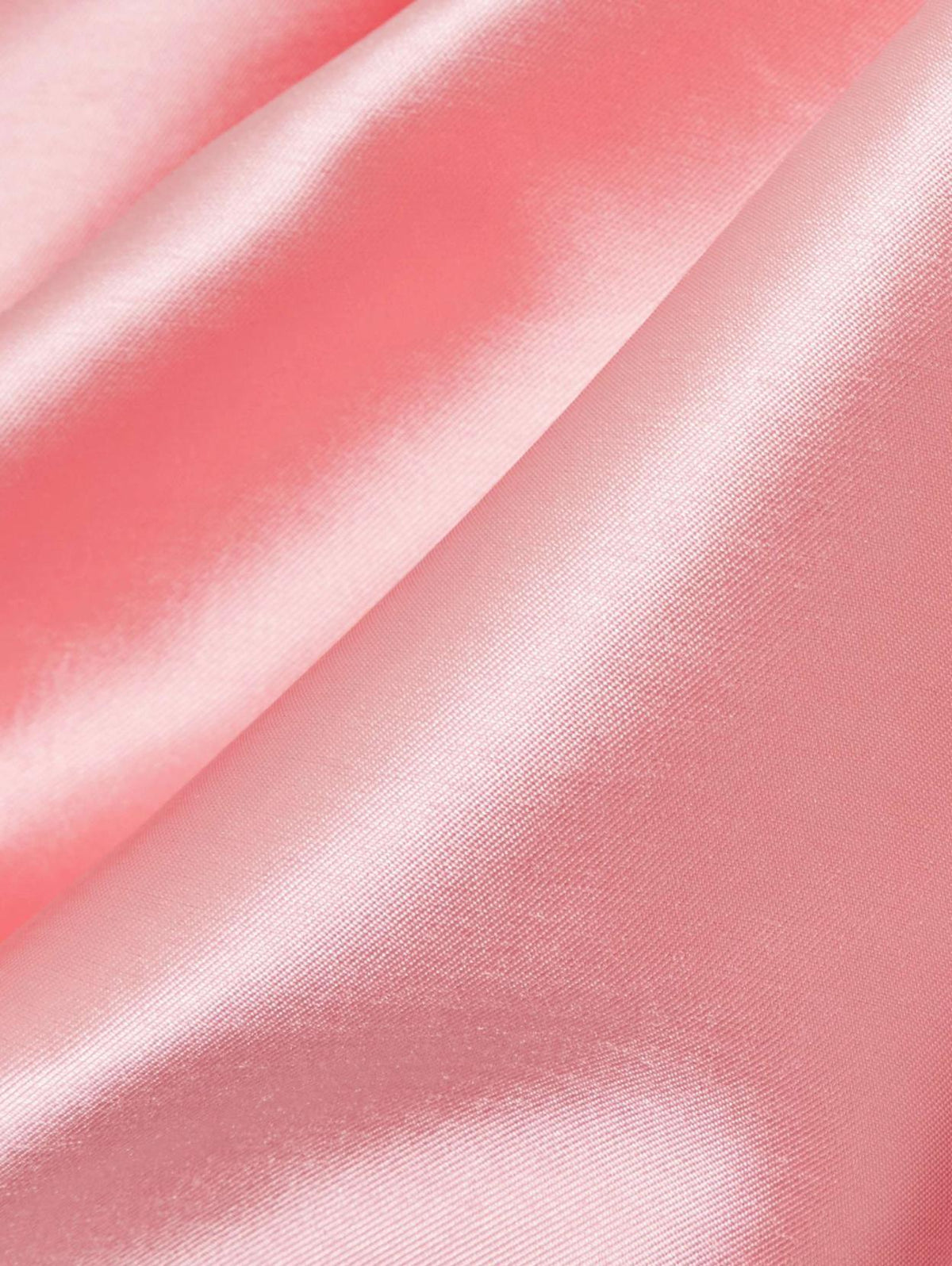 Close-up of soft, lustrous pink Mikado satin fabric with elegant folds for an Edition evening gown.