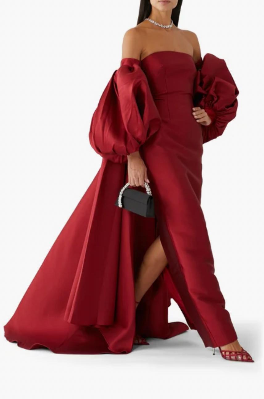 Strapless red Mikado satin evening gown with dramatic puff sleeves and a floor-length train.