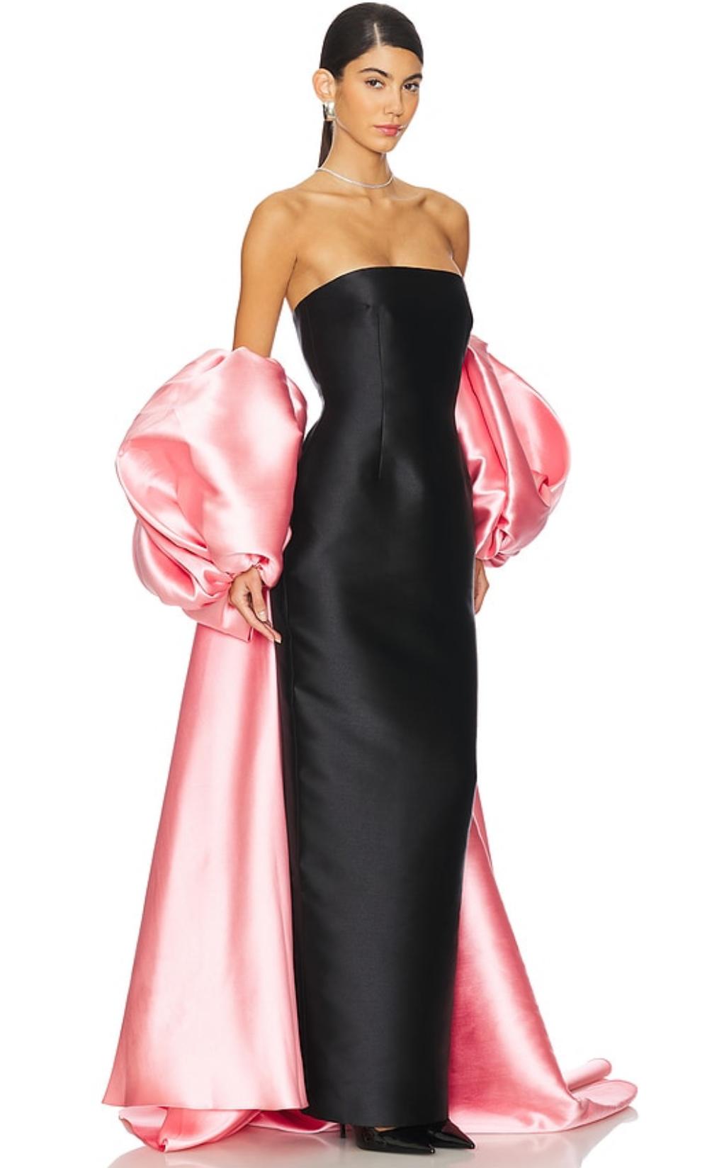 Strapless black satin evening gown featuring a dramatic, removable pink puff sleeve cape and full-length straight hem.