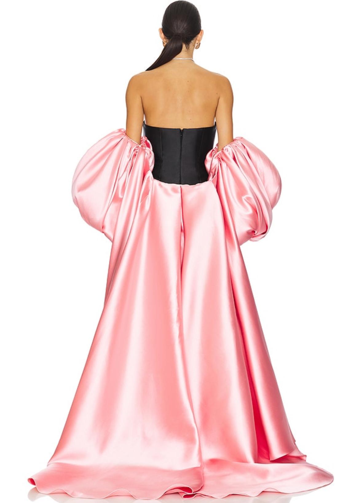 Strapless black and pink satin evening gown with a boned bodice and voluminous removable puff sleeve cape.
