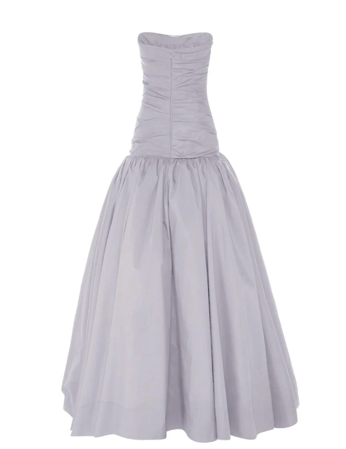 Strapless grey taffeta gown featuring a hand-draped bodice, structured fit, and a full, voluminous skirt.