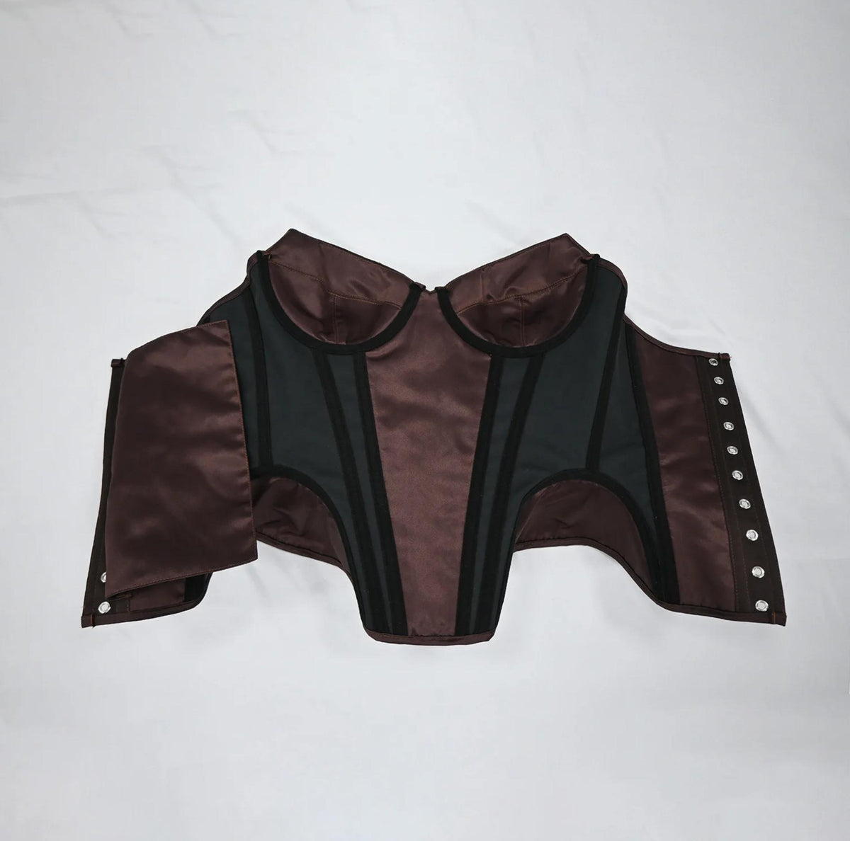 Brown satin corset bustier with structured black boning, sweetheart neckline, and metal hook-and-eye front closure.