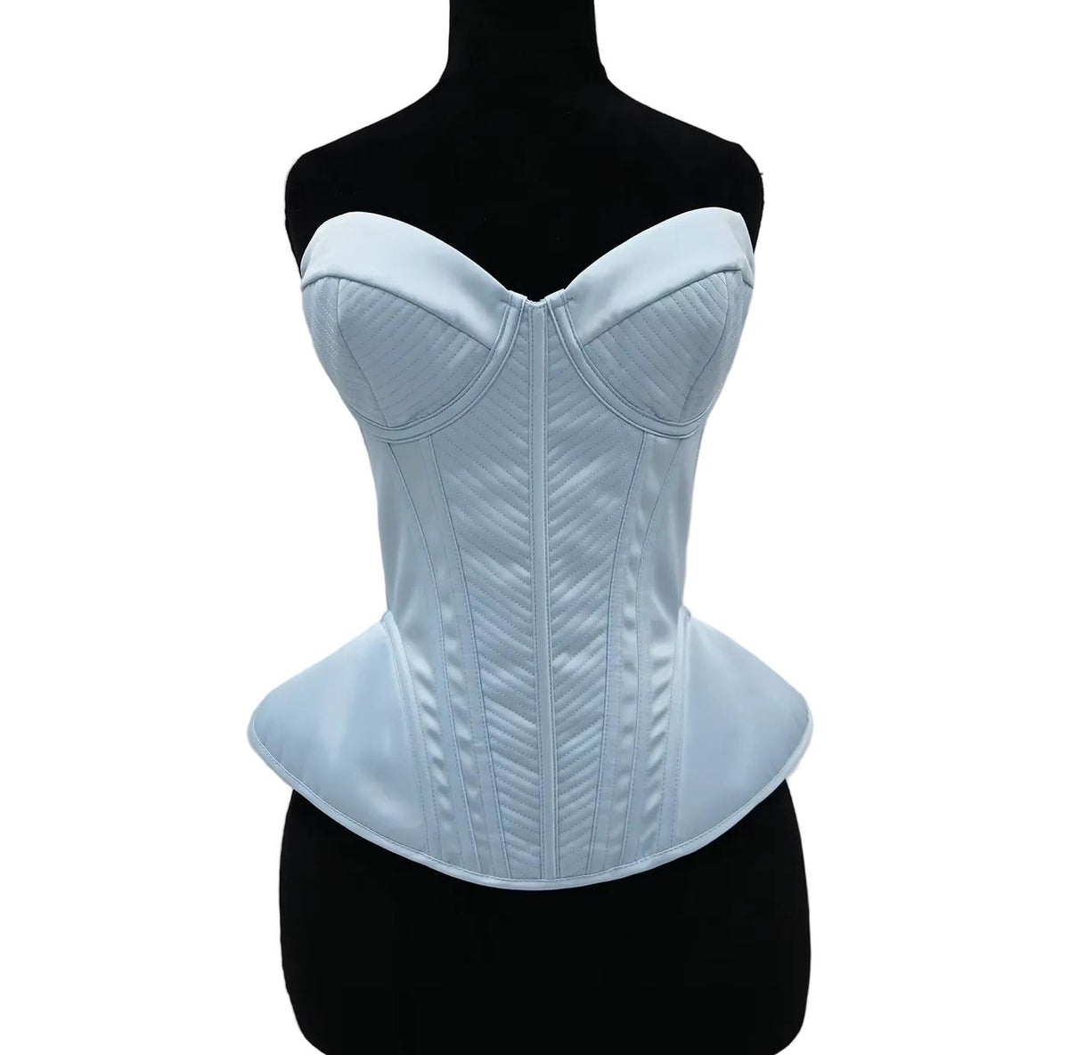 Light blue structured corset bustier with quilted stitching and a peplum waist on a black mannequin.